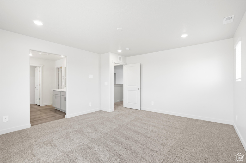 Spare room with light carpet and recessed lighting