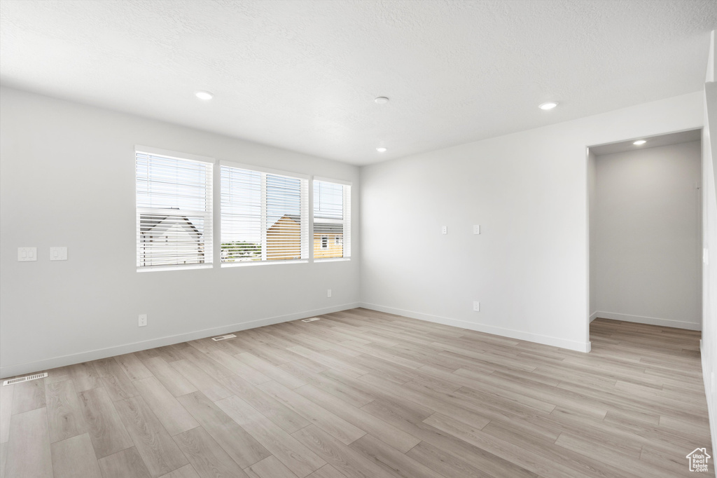 Unfurnished room featuring light wood-type flooring and recessed lighting