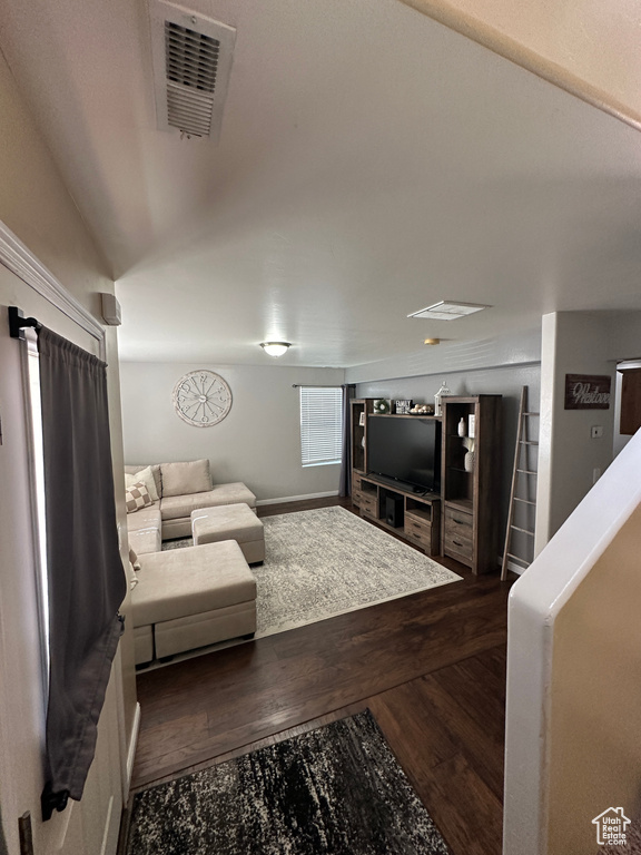 Living area with visible vents and dark wood-style flooring