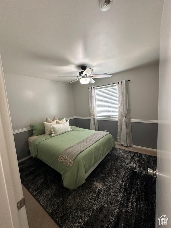 Bedroom with baseboards and a ceiling fan