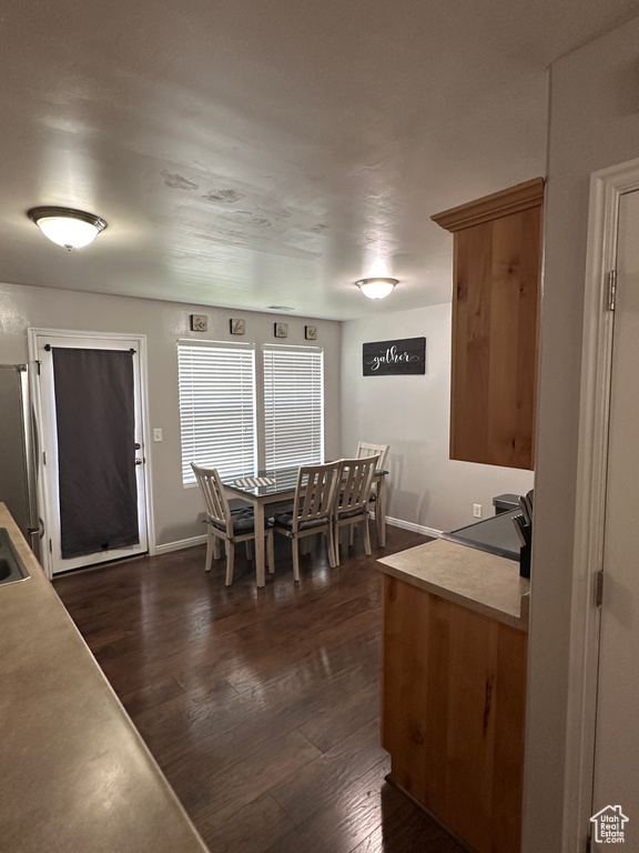 Dining room with baseboards and dark wood-type flooring