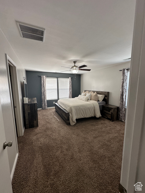 Bedroom with a ceiling fan, carpet flooring, and visible vents