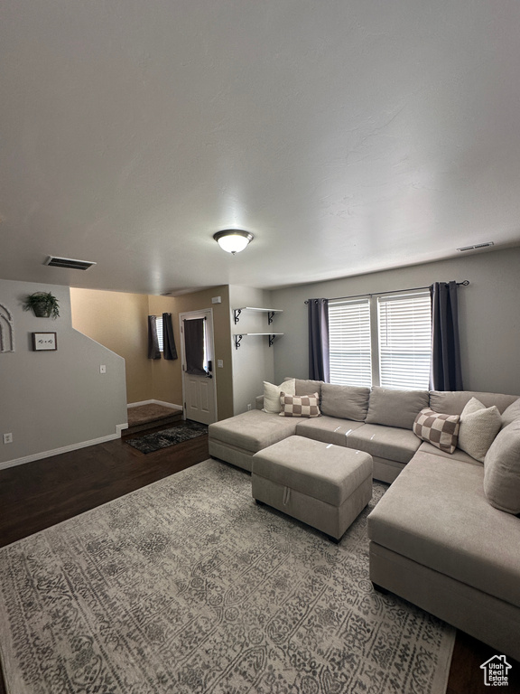 Living room with baseboards, wood finished floors, and visible vents