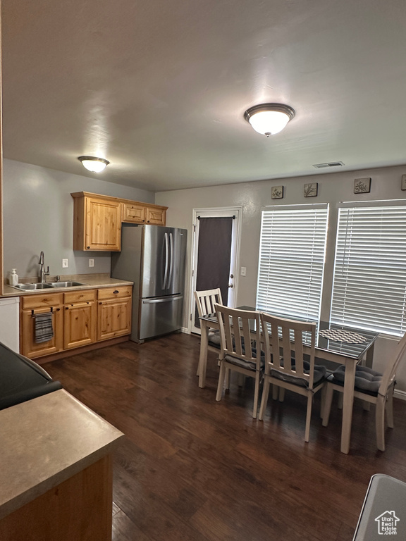 Dining area with visible vents and dark wood-type flooring