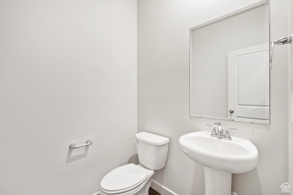 Bathroom featuring toilet and baseboards