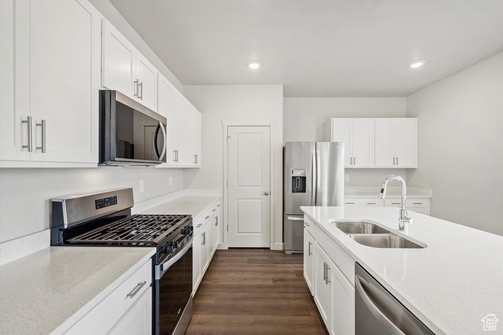 Kitchen featuring appliances with stainless steel finishes, recessed lighting, dark wood-style floors, and white cabinetry