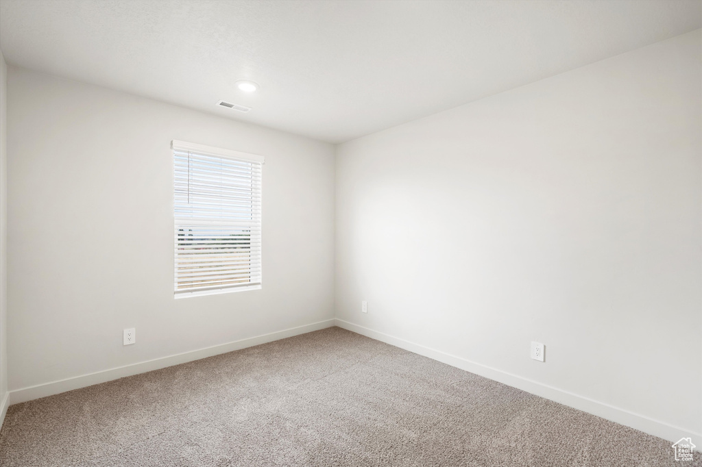 Carpeted spare room featuring baseboards and recessed lighting
