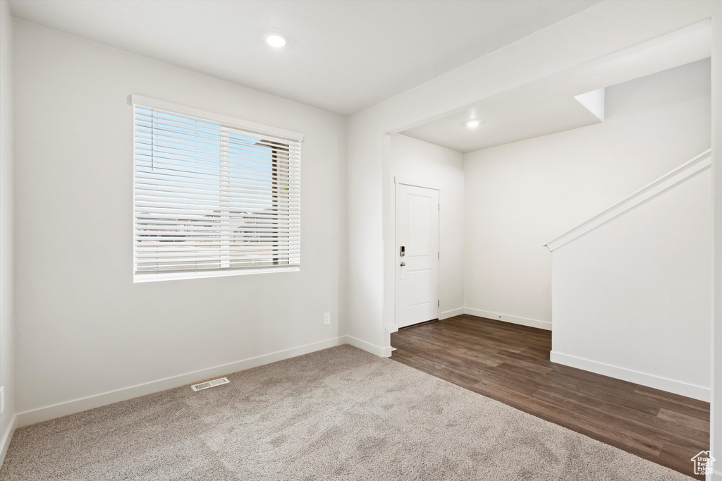 Foyer entrance featuring recessed lighting, dark carpet, and dark wood-type flooring