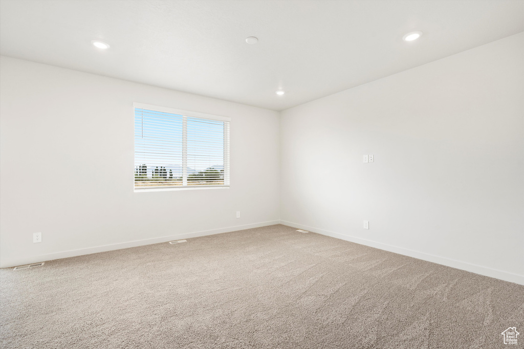 Empty room featuring carpet flooring and recessed lighting