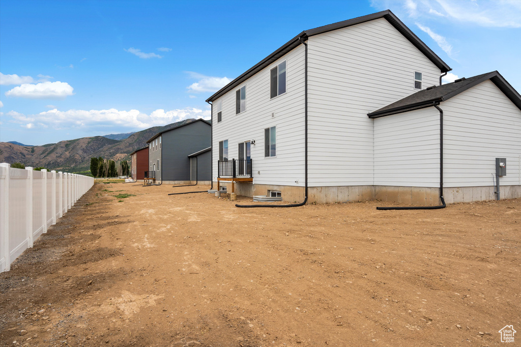Back of property with a mountain view
