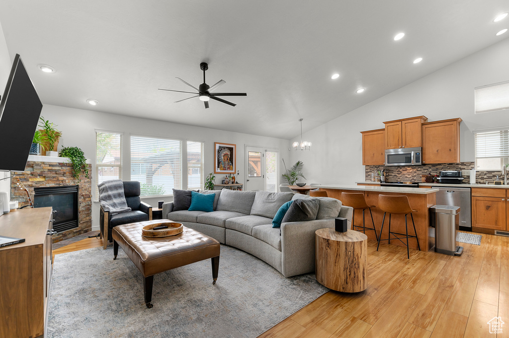 Living area featuring a fireplace, plenty of natural light, and light wood finished floors
