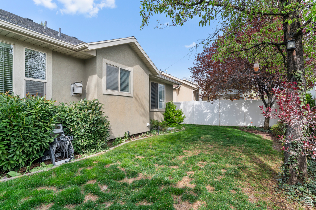 View of yard featuring fence