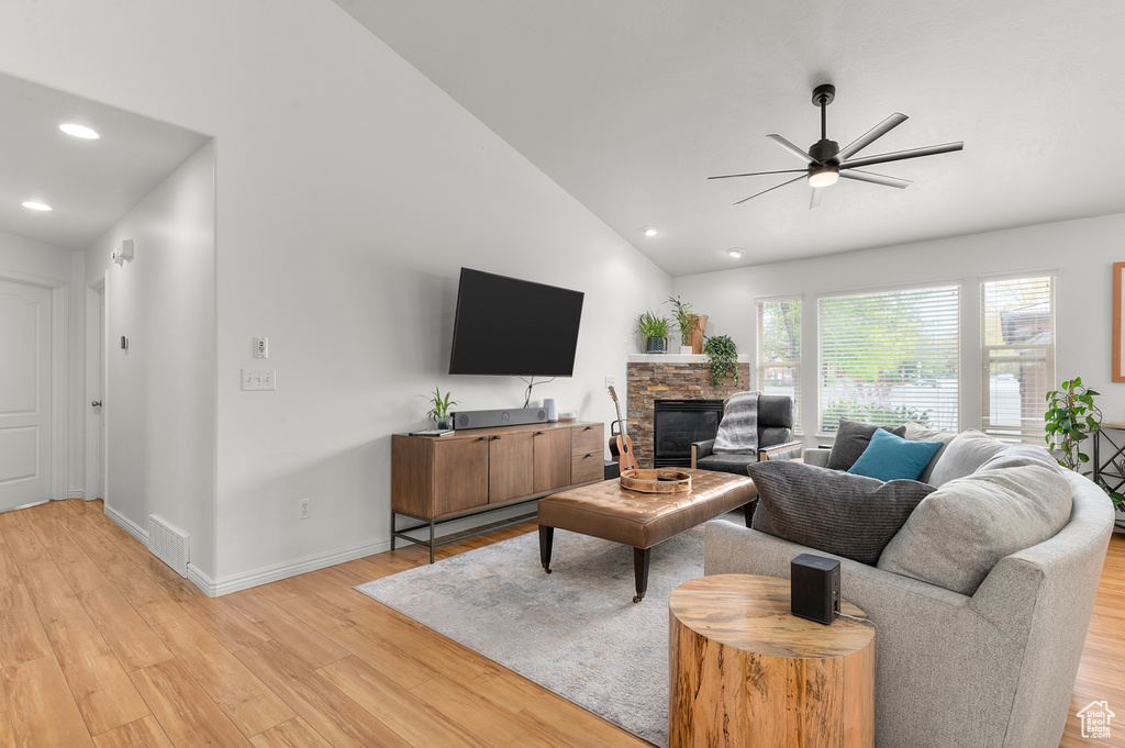 Living area featuring a ceiling fan, light wood-type flooring, lofted ceiling, visible vents, and recessed lighting