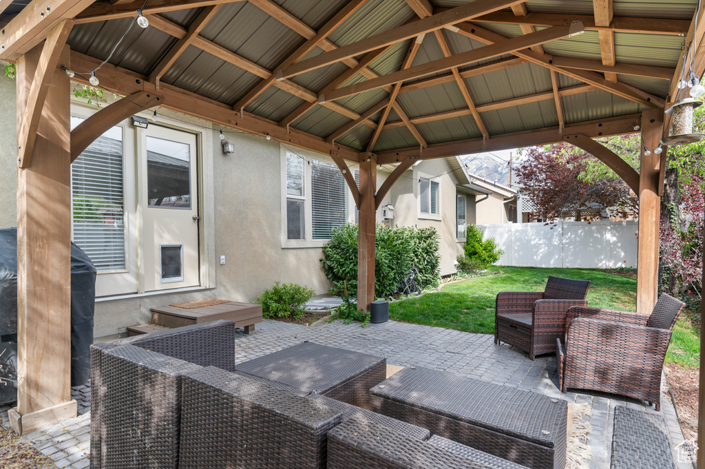 View of patio / terrace with a gazebo, fence, and an outdoor living space