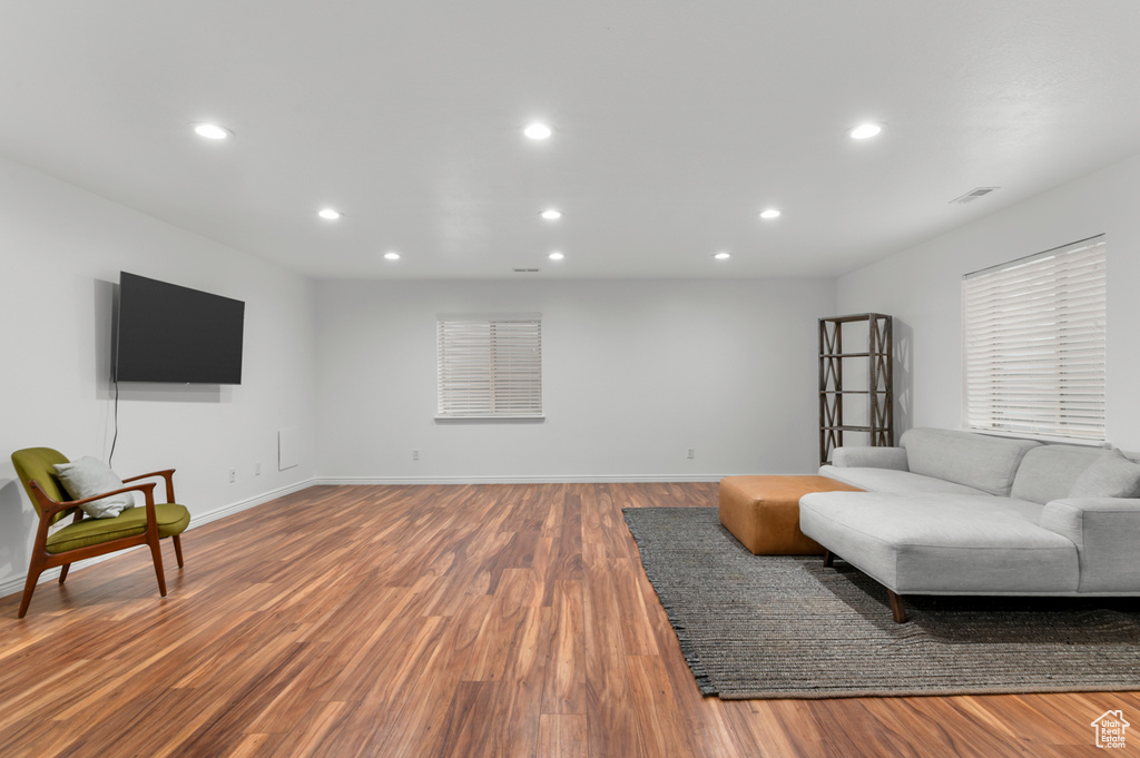 Living room featuring recessed lighting, wood finished floors, visible vents, and baseboards