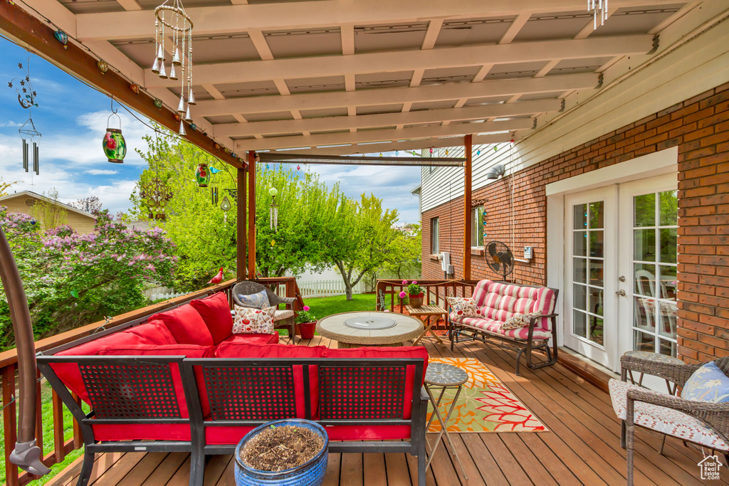 Deck with an outdoor hangout area and french doors