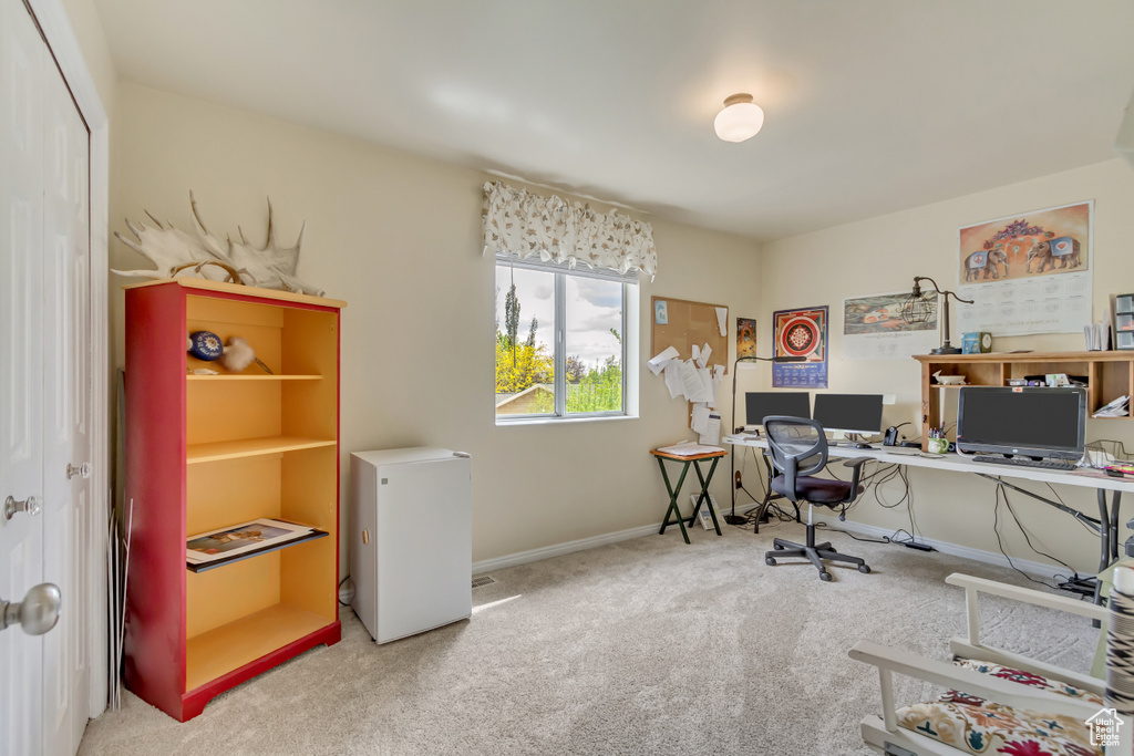 Carpeted office space with baseboards