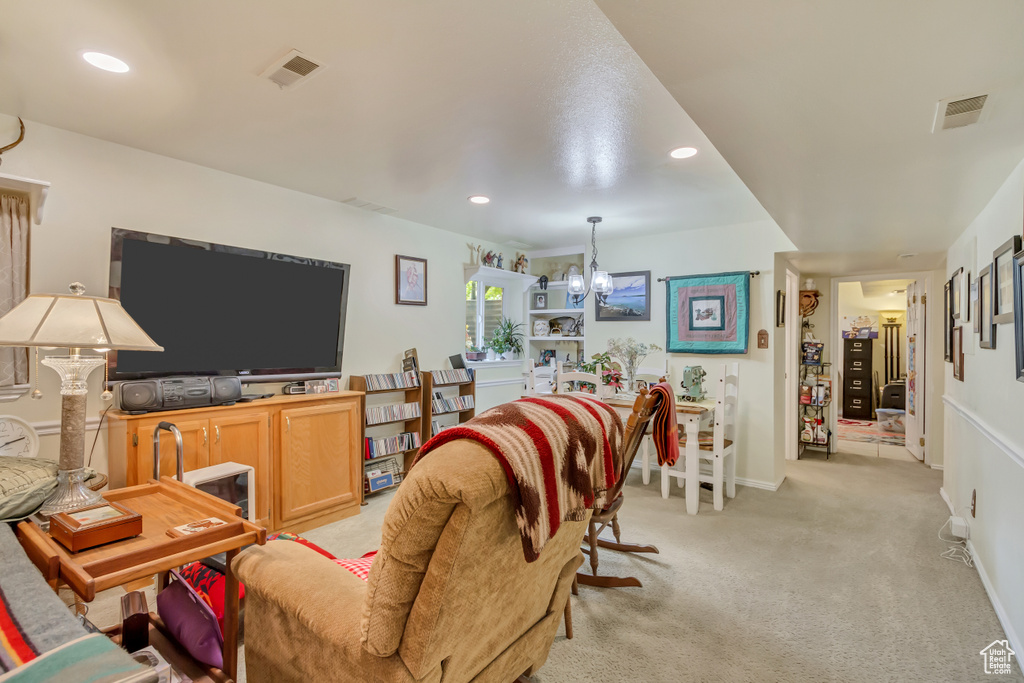 Living room featuring recessed lighting, visible vents, light carpet, and an inviting chandelier