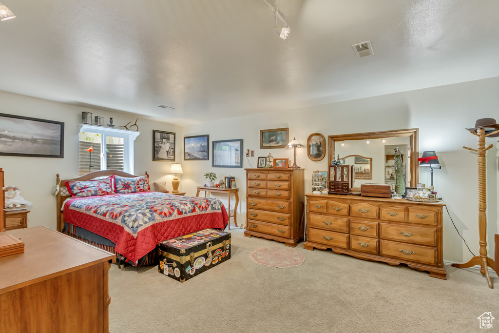 Bedroom with light carpet and visible vents