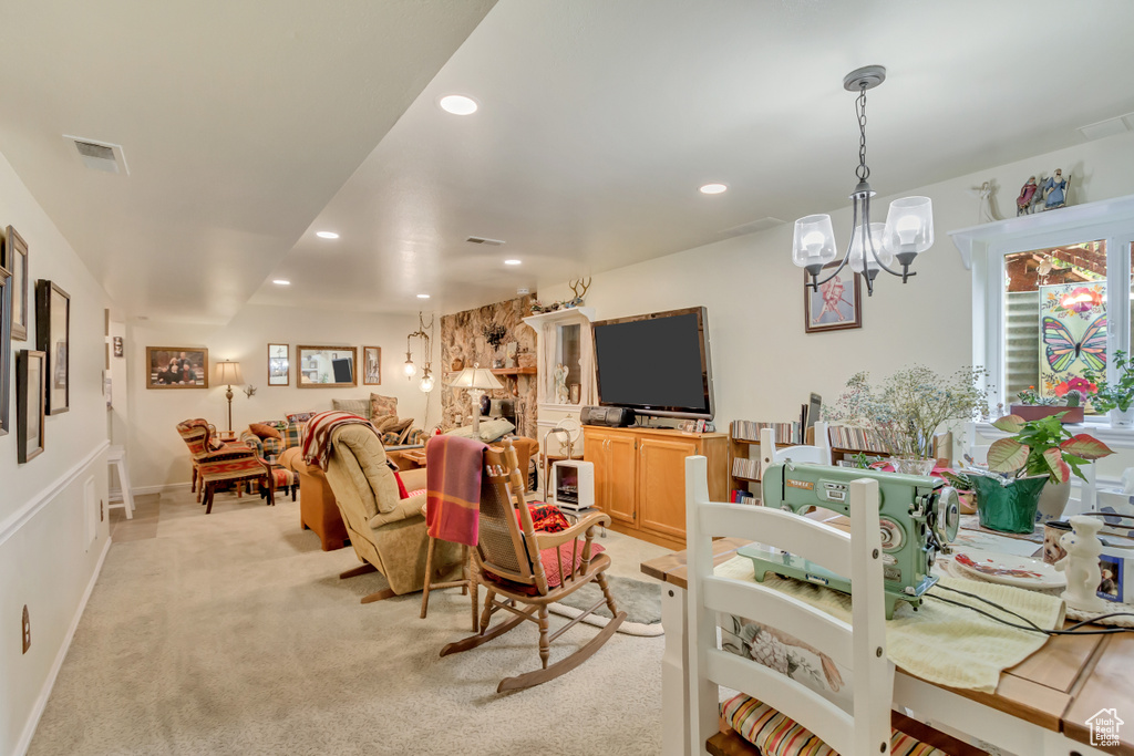 Living room with light carpet, visible vents, an inviting chandelier, and recessed lighting