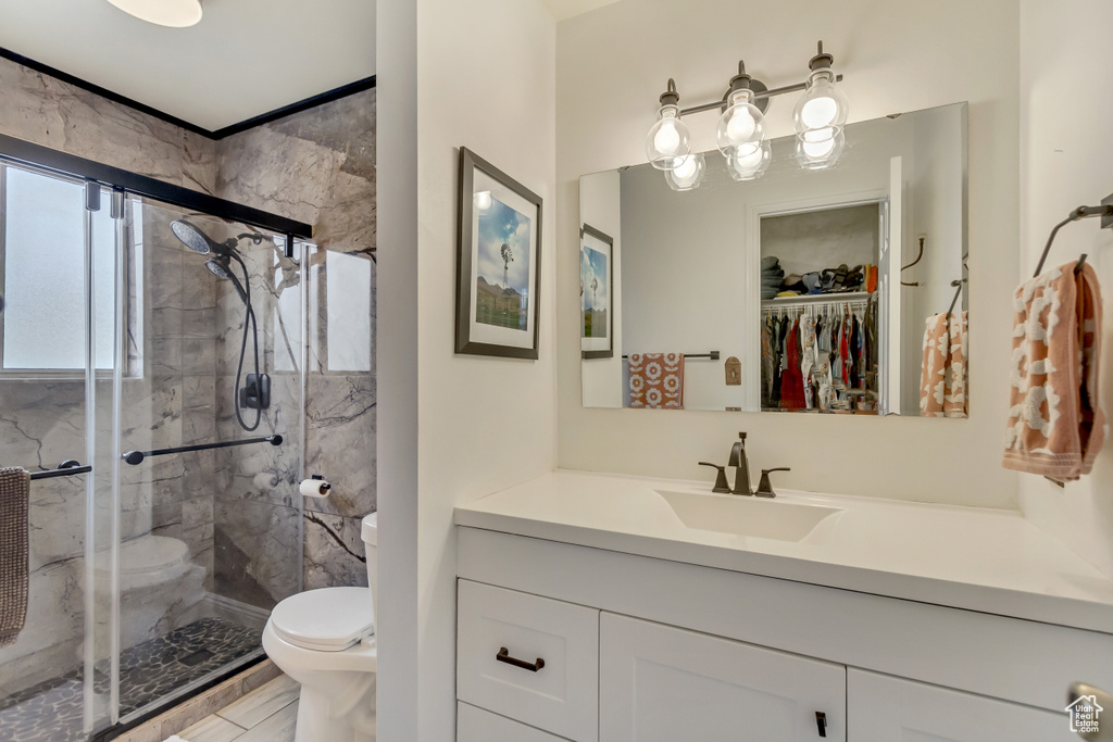Full bath featuring a shower stall, toilet, and vanity