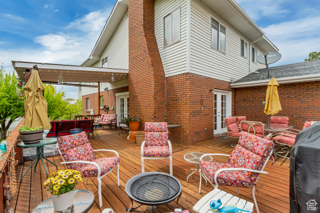 Deck featuring outdoor lounge area, french doors, and outdoor dining space