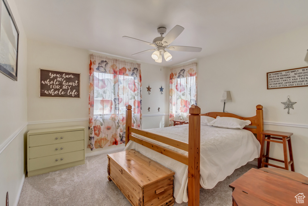 Carpeted bedroom with ceiling fan