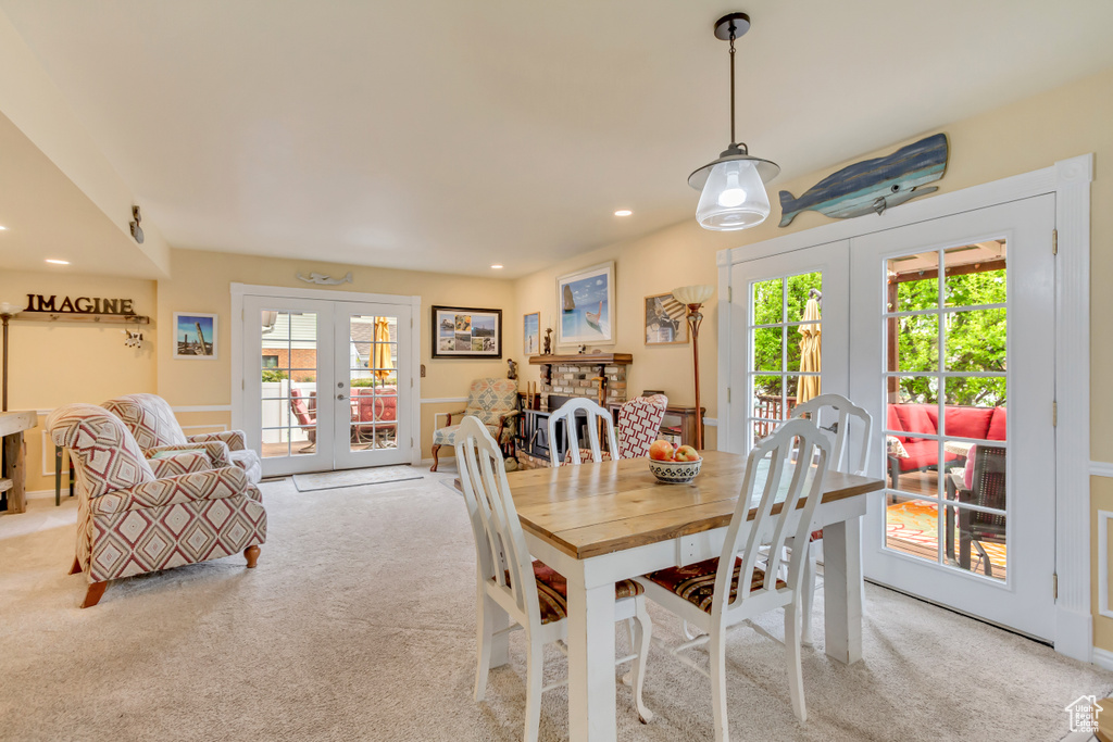 Dining space with light carpet, french doors, and recessed lighting