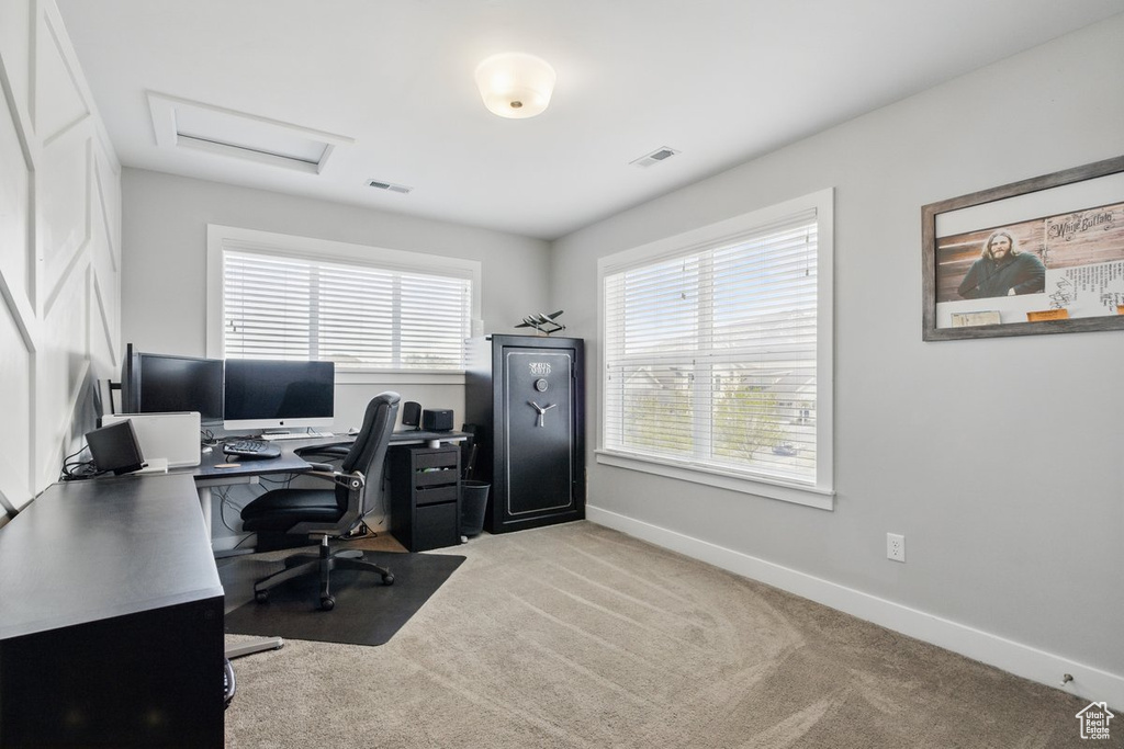 Office with visible vents, attic access, baseboards, and light colored carpet