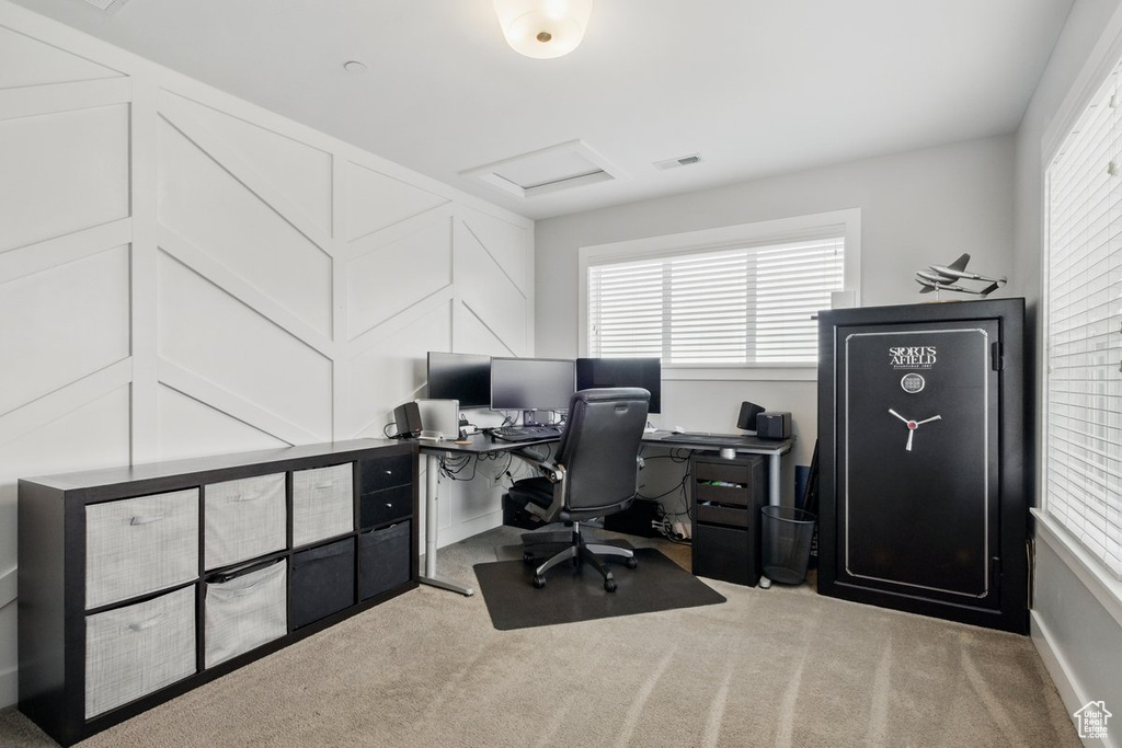 Carpeted office with visible vents and attic access
