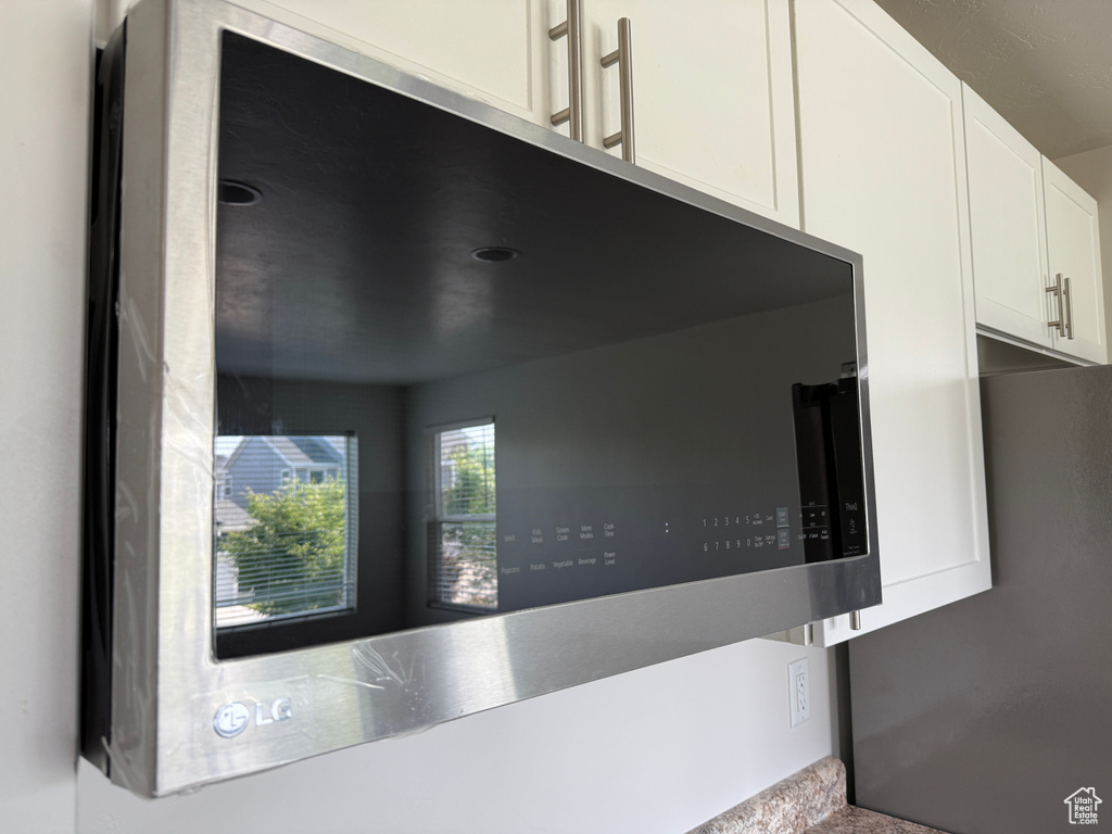 Kitchen view of white cabinetry