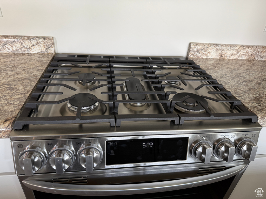 Detailed view of stainless steel range with gas cooktop