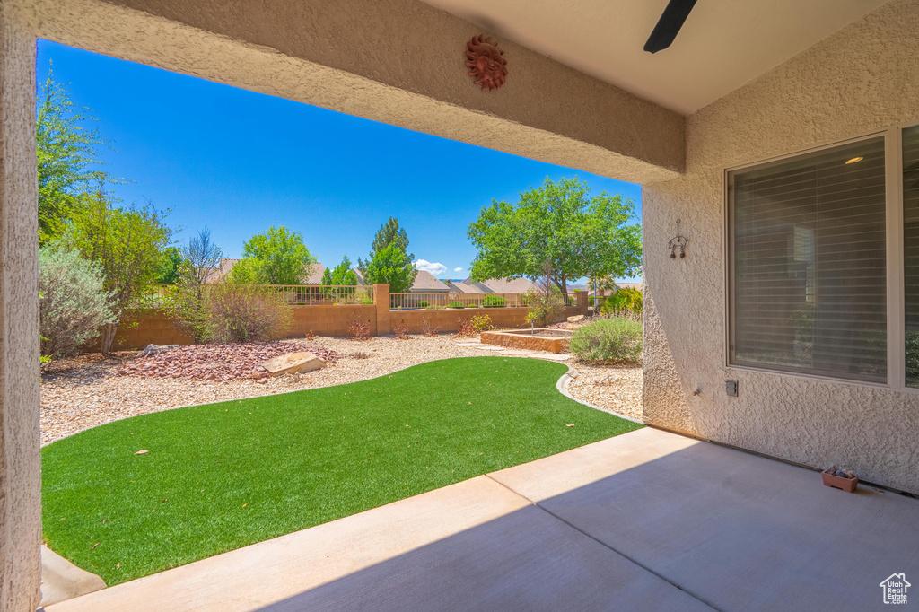 View of yard featuring a patio area and ceiling fan