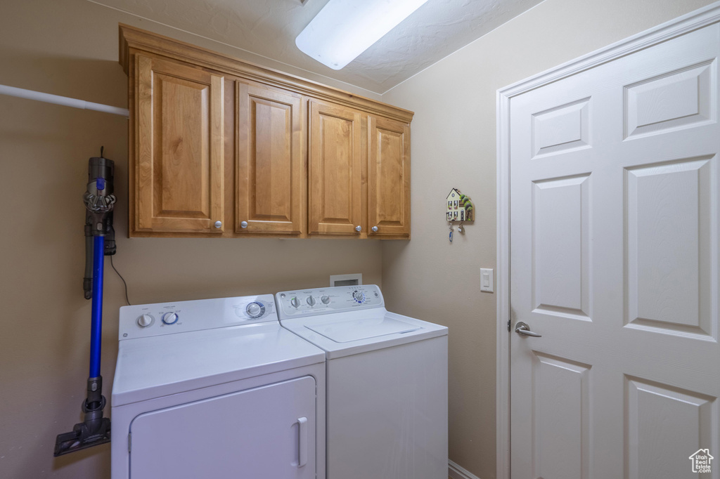 Laundry room with cabinet space and independent washer and dryer