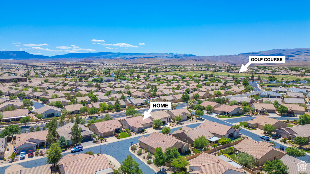 Aerial perspective of suburban area featuring a mountainous background