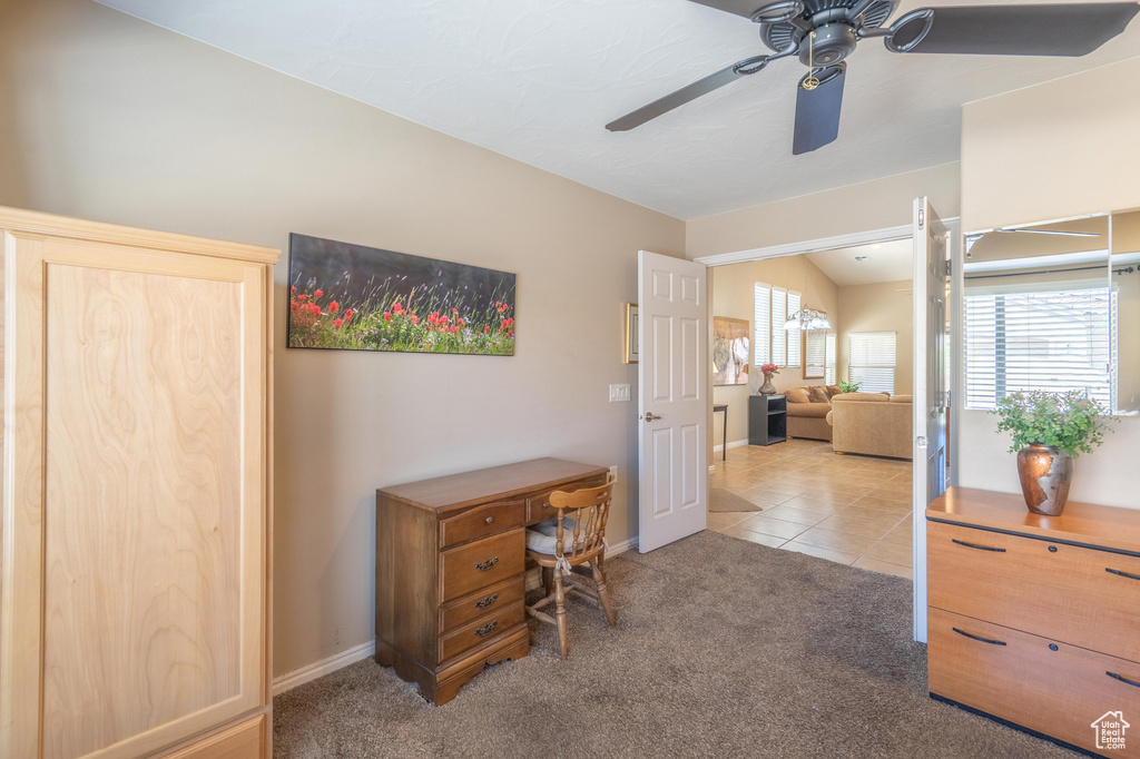 Office space with light colored carpet, ceiling fan, baseboards, and light tile patterned floors