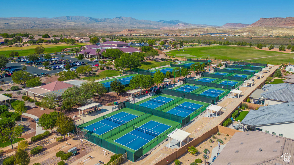 Aerial perspective of suburban area featuring a mountain backdrop and a golf course