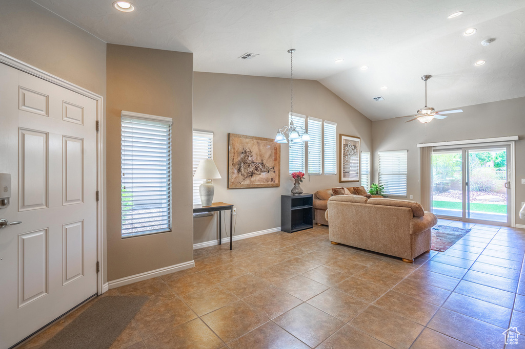 Living room with recessed lighting, baseboards, a ceiling fan, light tile patterned flooring, and high vaulted ceiling