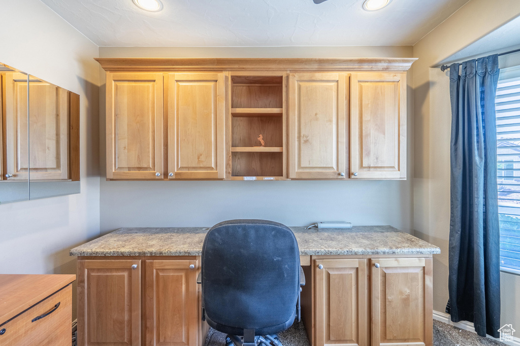 Office area featuring built in study area and recessed lighting