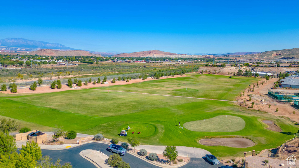 Aerial view of a mountain backdrop and a local golf course