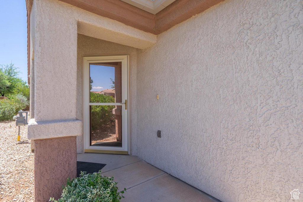 Entrance to property with stucco siding