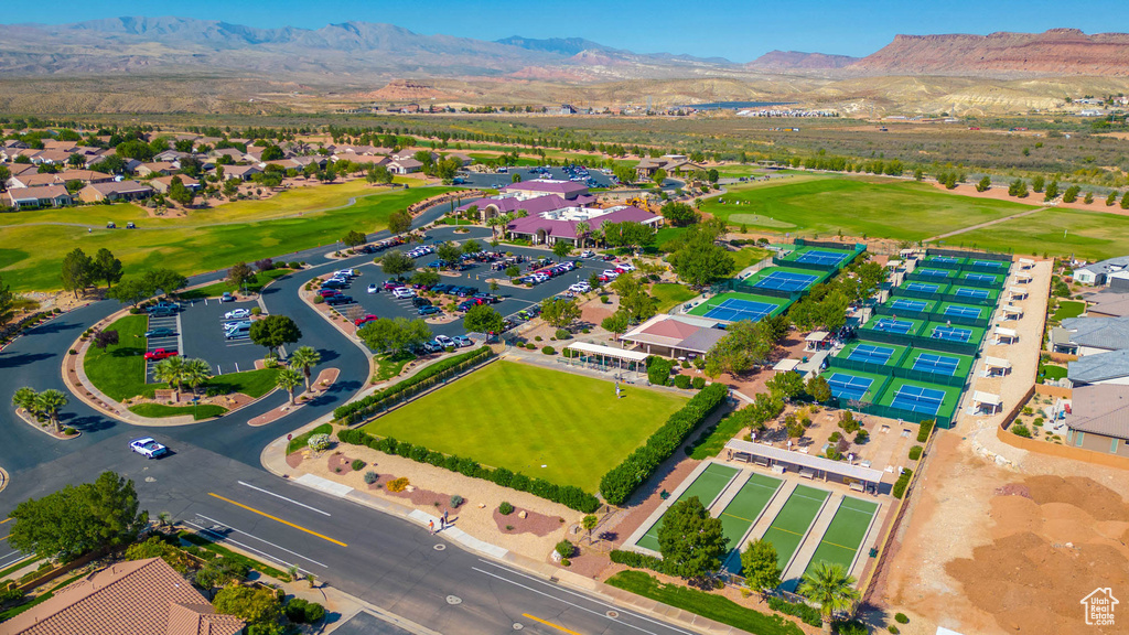 Drone / aerial view of a mountain backdrop and a golf club