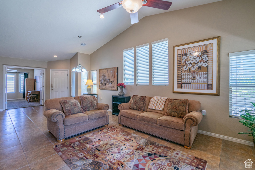 Tiled living area with plenty of natural light, lofted ceiling, baseboards, ceiling fan, and recessed lighting
