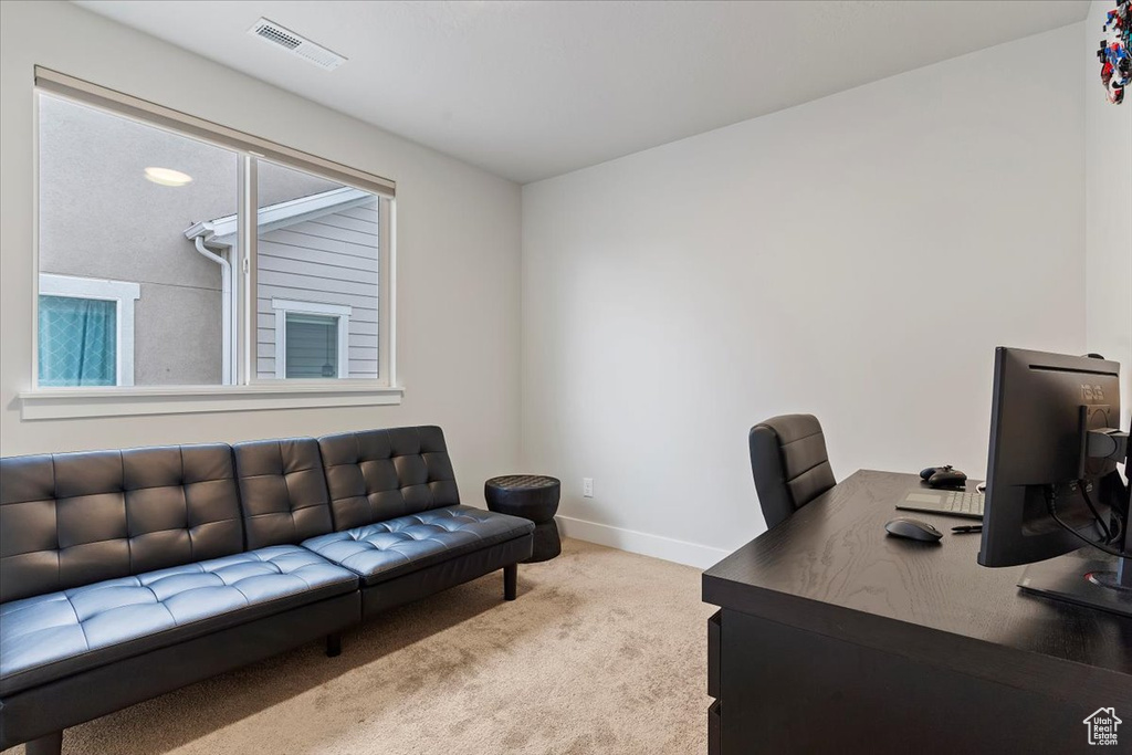 Carpeted home office featuring baseboards and visible vents
