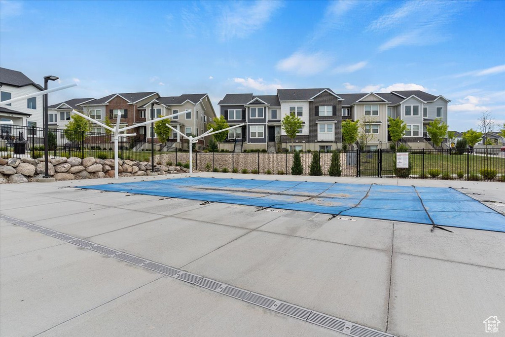 Pool featuring a residential view and fence
