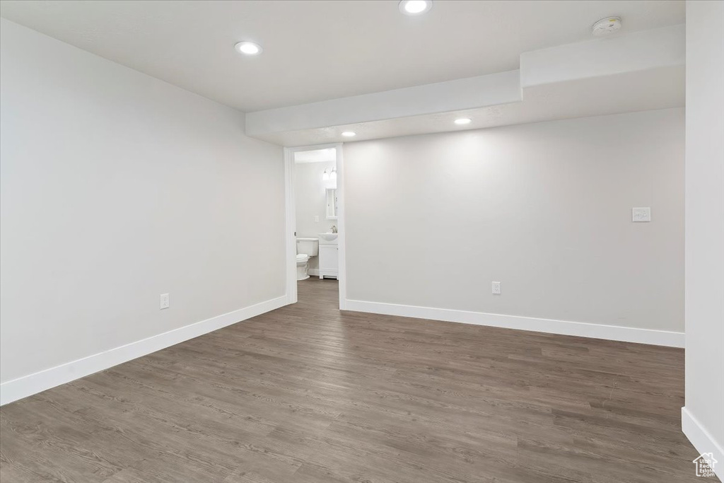 Finished basement featuring recessed lighting, wood finished floors, and baseboards