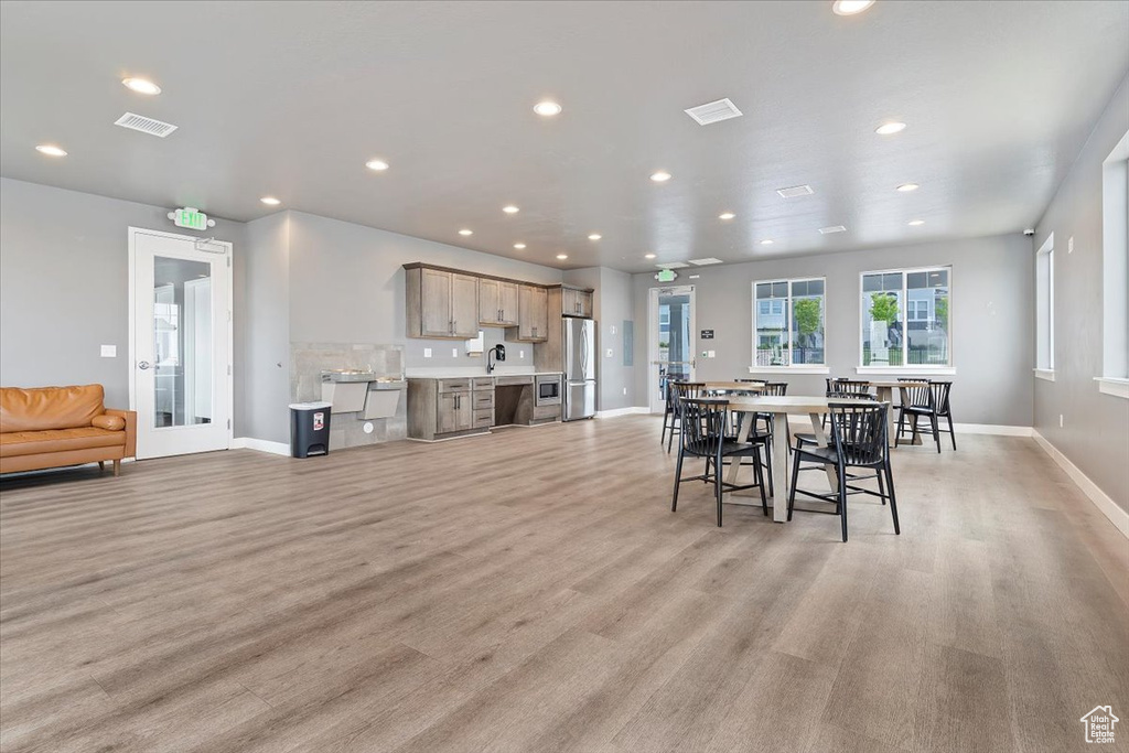 Dining area with recessed lighting, visible vents, light wood finished floors, and baseboards