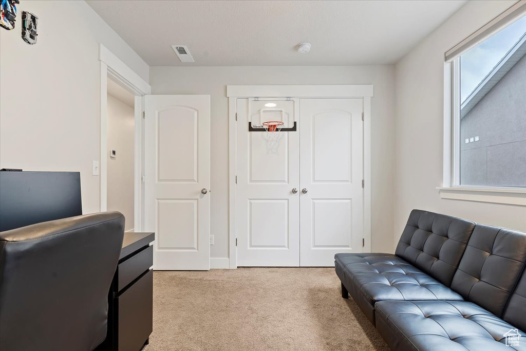 Office area featuring visible vents and light colored carpet