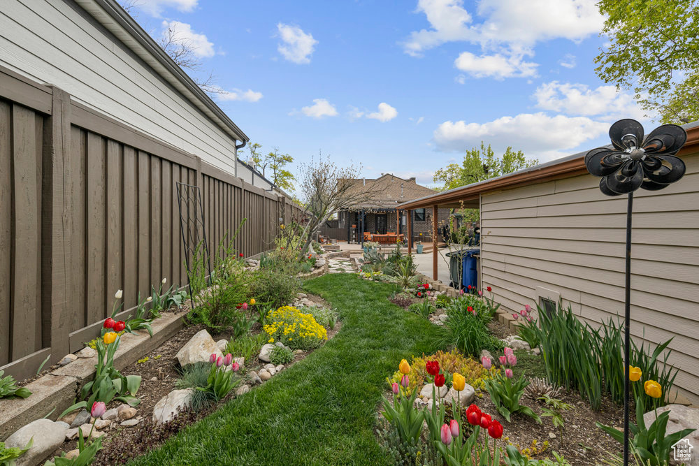 View of yard with fence and a patio area