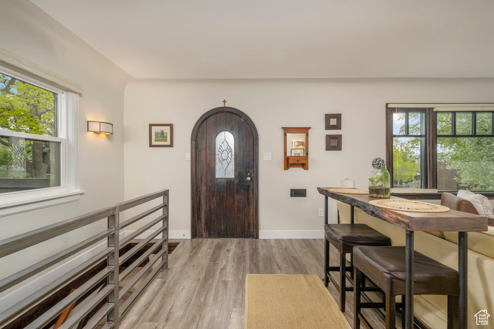 Entryway with wood finished floors and baseboards